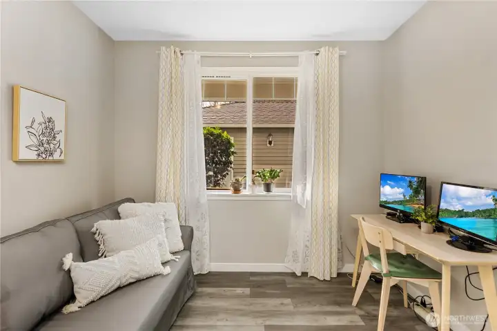 Its separation from the primary suite provides privacy for visitors or household members. Natural light keeps the room feeling bright and comfortable throughout the day.