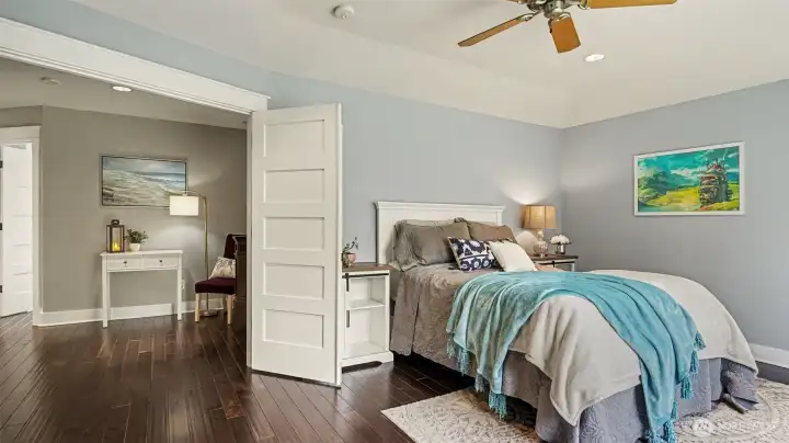 The sumptuous primary suite has a double door entry, 5-piece bathroom, & large walk-in closet w/ organizers.