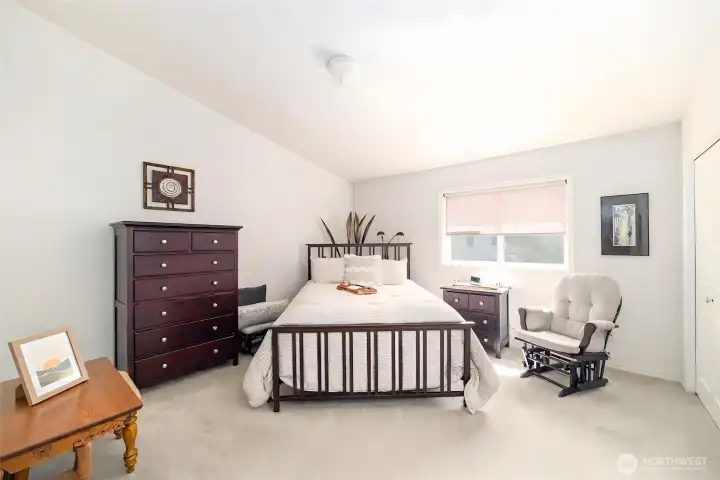 Spacious primary bedroom with room for a full bedroom set and additional seating