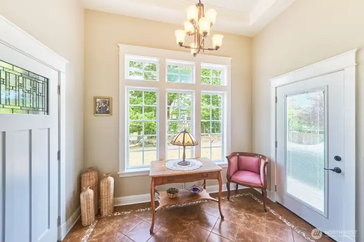 The tiled entry hall offers durability and style, with easy access to the north-facing deck and firepit area.