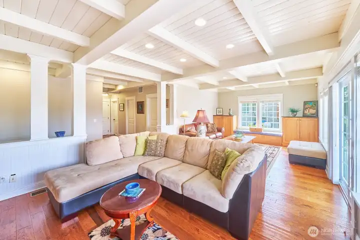 The mid-level family room features beautifully finished ceilings and direct access to a covered deck - ideal for guests of multi-generational living.