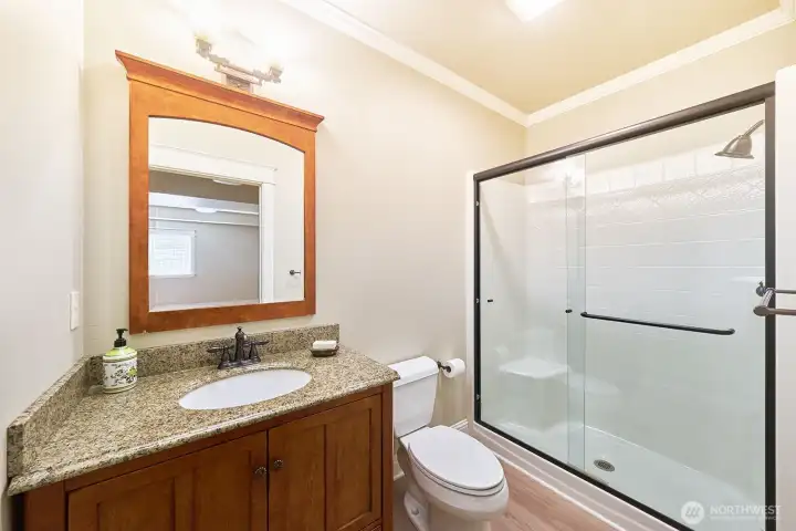 An attached 3/4 bath adds convenience and functionality to the lower-level living space.