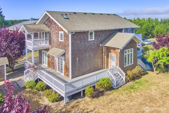 Decks on three sides of the home seamlessly expand the living space outdoors, inviting sun, sea air, and connection to the coastal surroundings.