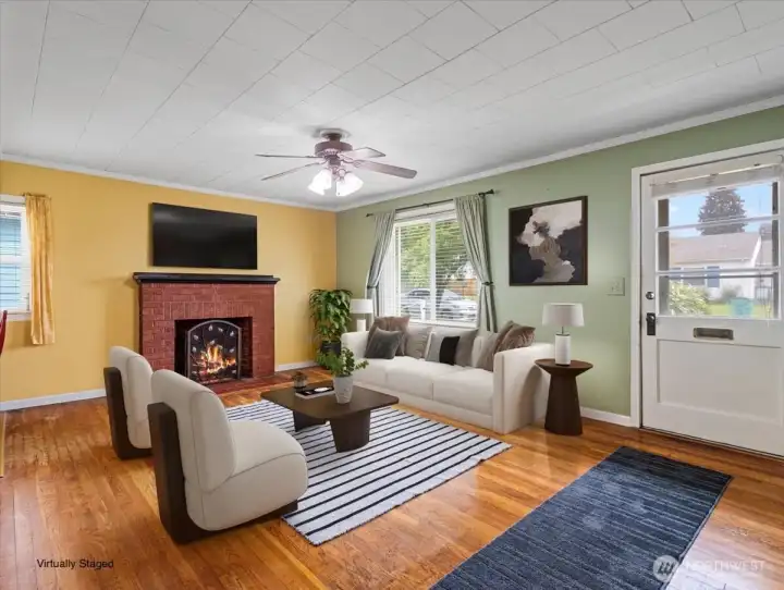 Living room, hardwood floors, wood-burning fireplace, ceiling fan, Virtually Staged
