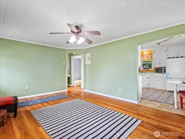 Living room, hardwood floors, wood-burning fireplace, ceiling fan