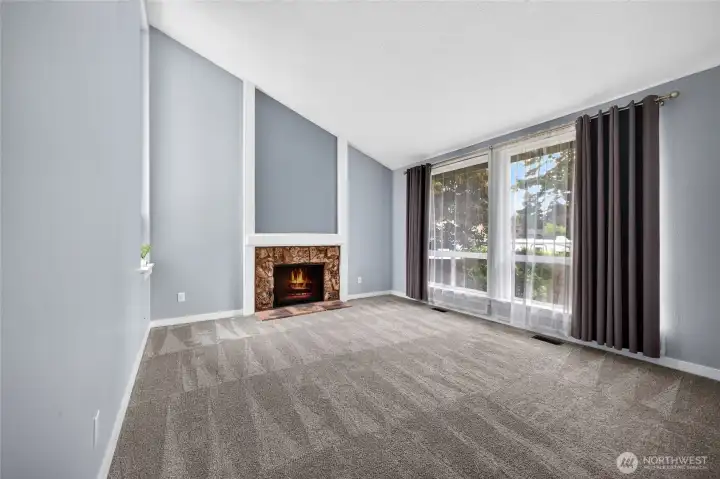 Soaring windows & vaulted ceiling create a bright & spacious formal living room!
