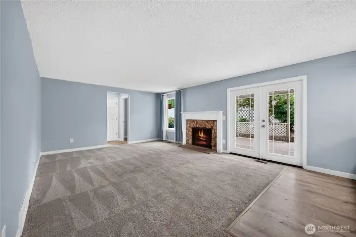 Family room with cozy firelplace and French doors leading to expansive back yard!