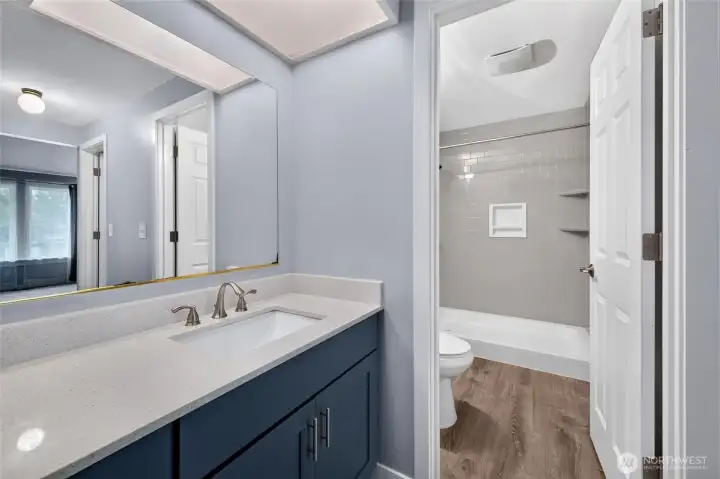Quartz counters & oversized shower are highlights of the primary bath!