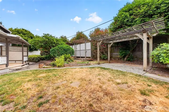 Paved walkways & outdoor trellises are unique features of this generous back yard!