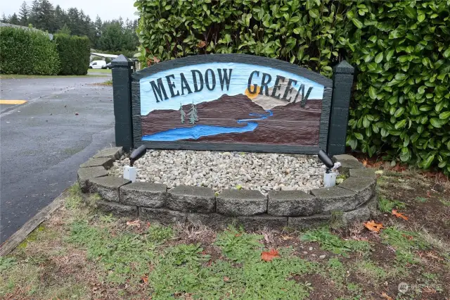 Meadow Green sign welcomes you in.  Small community that wraps around a circle.