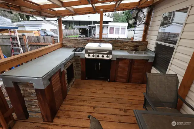 Outdoor kitchen for all the entertaining! Check out those bev fridges and range!