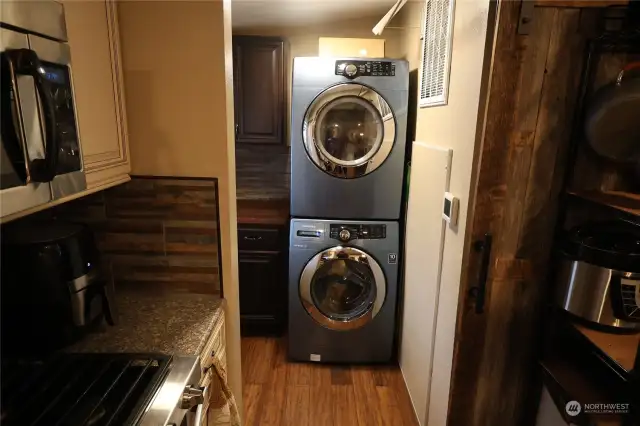 Utility room with barn door that separates kitchen.