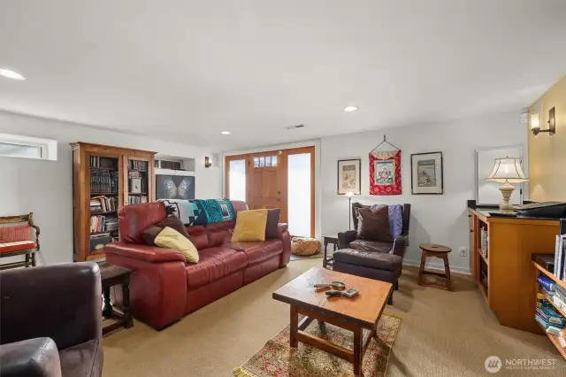 Here you can see the family media room with its separate door to the outside. Every door in the home has clear or obscure glass panels to allow natural light to enter each room.