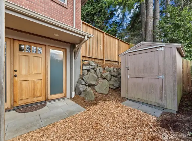 The lower level has its separate entrance and small outdoor area with a shed for storage. Sidelight windows and lights on the door draw light within the family room ground floor. ADU possible?