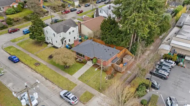 Drone photo at higher elevation with car parked perpendicular to the curb cut.