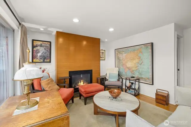 Stunning gas fireplace! Clear vertical grain fir wraps the chimney wall with a natural stain that stands counterpoint to the wood throughout the house.