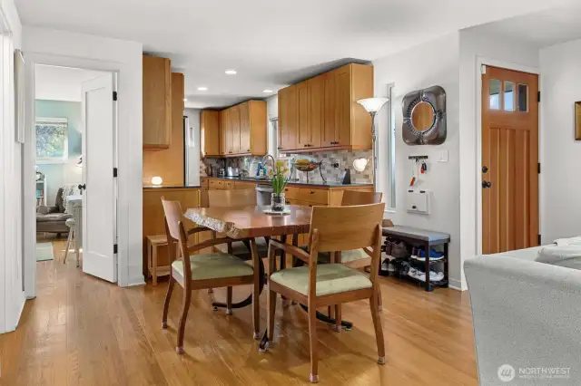 Dining area that defines an open boundary between kitchen and living room.