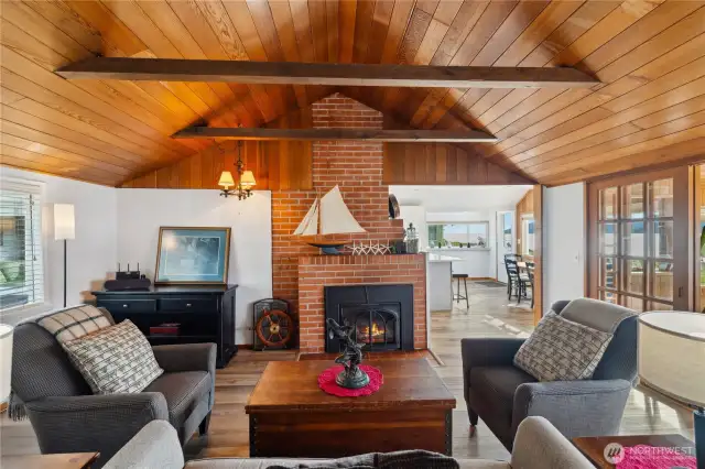 Living room fireplace dominates the room.  Dining room to right, kitchen in the middle with eating area.