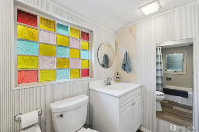 Primary full bath has touches of the original 1910 home.