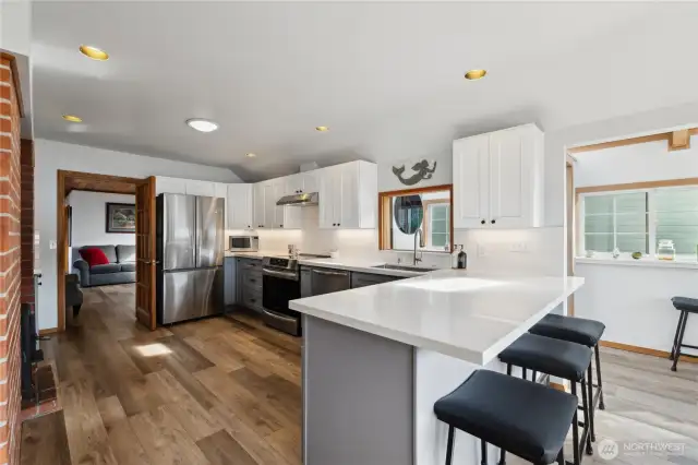 Kitchen leads into a "flex" room and one of the two bedrooms and bath.