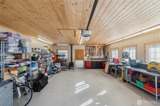 Inside the garage.  Note the windows and wood stove.  This could be easily converted to more living space.