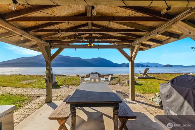 Beach side kitchen cabana has sink, fridge, countertops, crab cooking station and is on that unbelievable beach.  Fire pit in front.