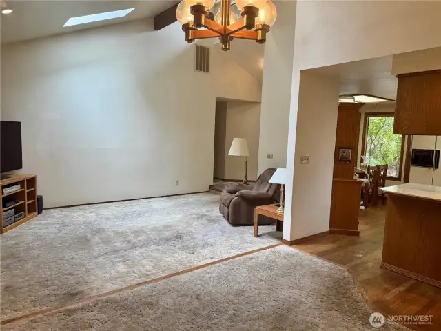 Living room, dining room and kitchen.  1 step down from dining room to living room.  HARDWOODS UNDER CARPETS THROUGHOUT HOME!!!!