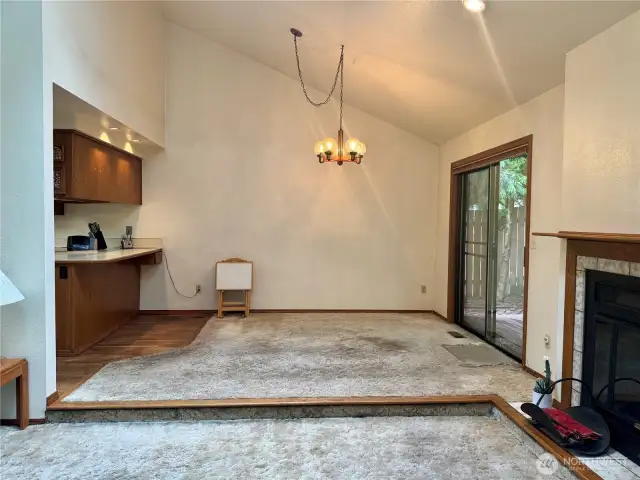 Dining room with hardwoods under carpet, and slider that leads to private backyard!