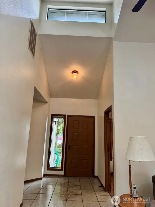 Entry has tile floor and architectural window.