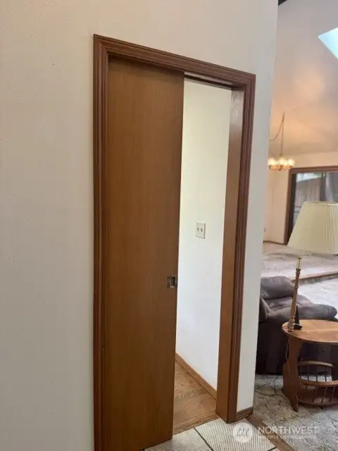 Pocket door off entry leads to kitchen.