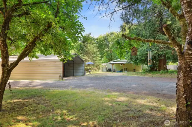Entering the property you can see the large, detached carport here.  6325 is seen ahead with attached carport.