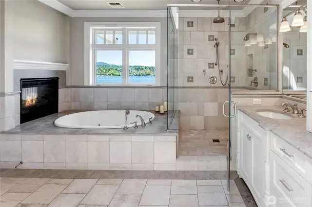 The two-sided fireplace above the bathtub completes this spa-like primary suite.