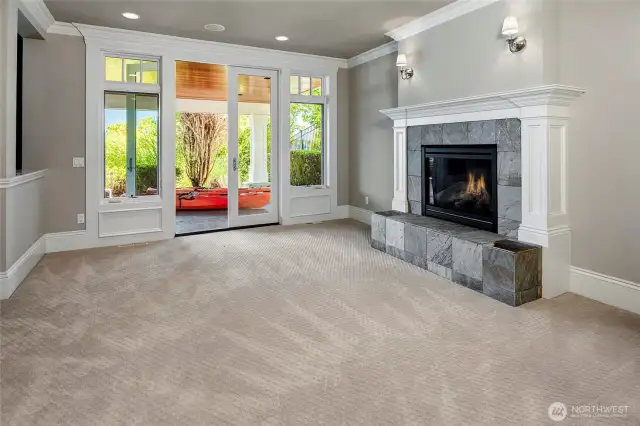 The lower level shows off an oversized rec room with the 4th and final gas fireplace, with another set of French doors leading to the covered patio and walkway to the waterfront.
