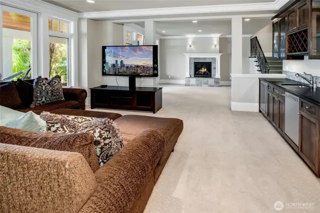 On the other side of the rec room sits an extensive wet bar, and additional seating or gaming area.
