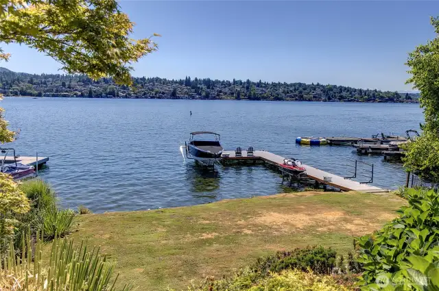 Walking down the perfectly manicured landscaped pathway to a level lawn with 66' of private waterfront.