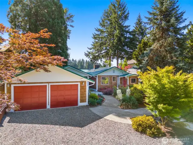 This charming home has loads of street appeal, with its inviting red touches and warm cedar shake siding and sturdy metal roof. Beautifully landscape pat the the entry is welcoming. Plenty of parking too....rare on the water.