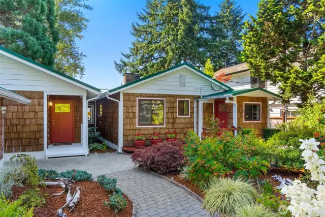 Covered front entry to the left, with cheery red front door.  Entry to the right goes to the mud/laundry room for messier trips!