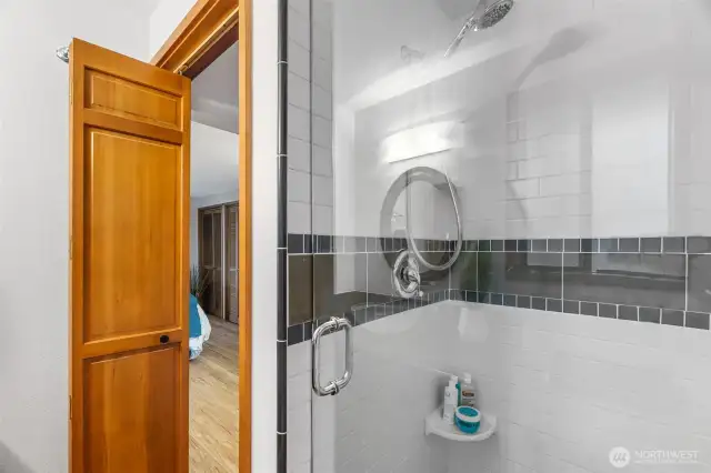 Full tile shower with wide swinging glass door