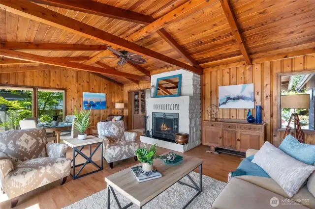 Bam! Round the corner to the other side of the house, and THIS awaits.  Breathtaking room, out of a magazine. Knotty pine walls with wood beam vaulted ceiling and generous, wood burning stone fireplace....all the goodies!