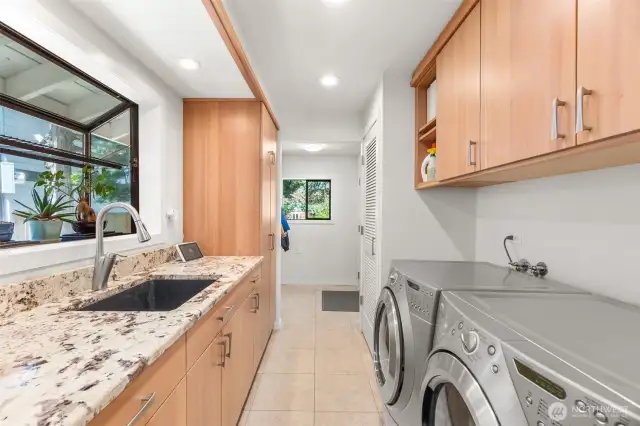 The custom bleached cherry cabinetry and White Alaska granite continues into the updated laundry/mud room.  You may even enjoy your time in here! There is room for everything, and the washer and dryer are included in the sale.