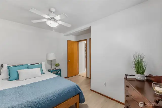 Spacious bedroom with ensuite bath is located off a hall, between the kitchen and laundrr/mud room