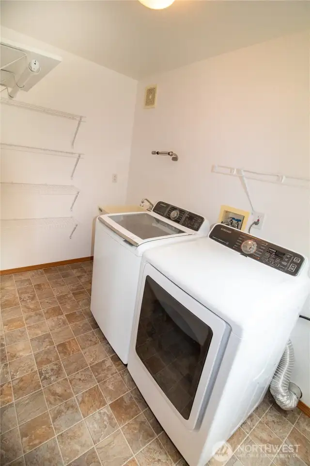 The utility room is spacious & includes shelving.