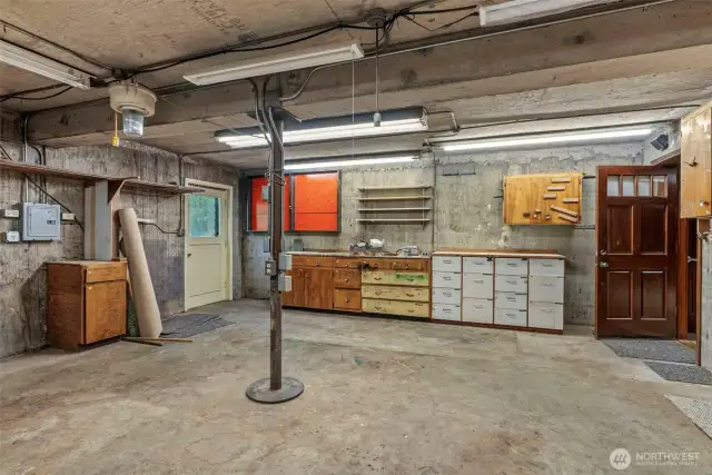 Workshop with Cabinetry, own electric panel, and outdoor access.
