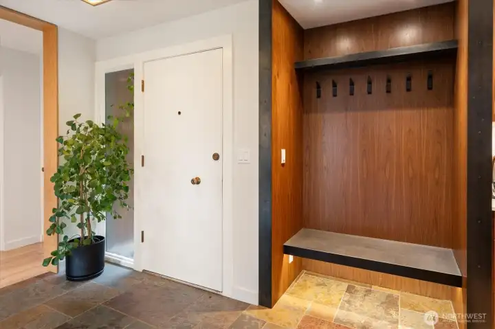 A slate entry, floating built in bench with hooks impress right away and promises more of the details to come.