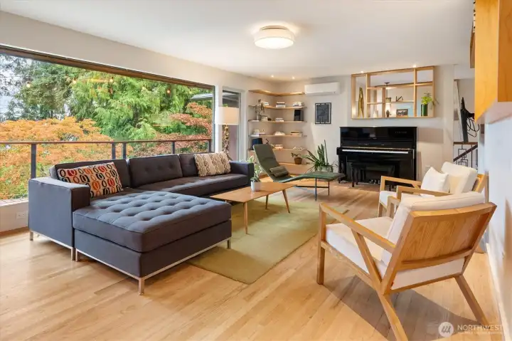 Another angle of the living room showcases the large picture window with Lake Washington and treetop views.