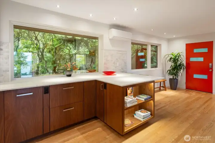 The kitchen also features a built in cookbook bookshelf.
