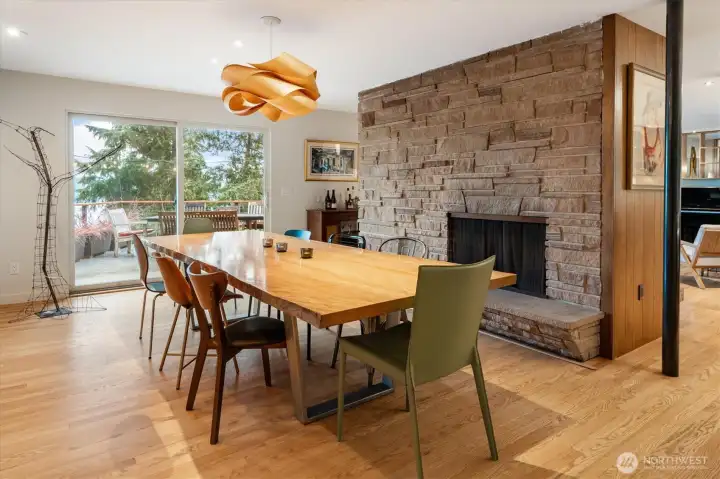 The sprawling dining room leads to the large deck, which features heavenly Lake Washington and treetop views.