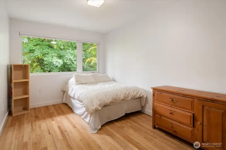 The third bedroom on the main floor is just as spacious and also features the window of trees.
