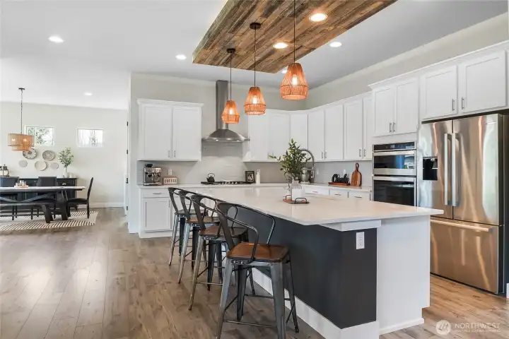 Quartz counters, soft close drawers, accent ceiling above huge island
