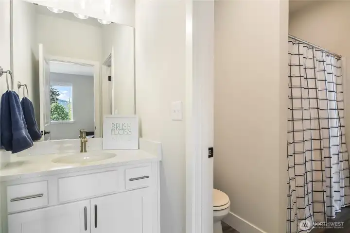 Upper level bedroom with access to bathroom; other vanity area accessed from open living area